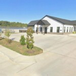 White building at front of drive up self storage facility